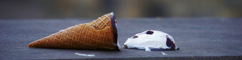 A picture of an ice cream cone on the ground